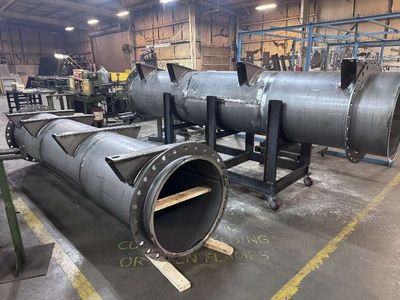 A large flanged silencer assembly on the Duravex shop floor
