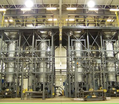 Industrial storage silos and structural steel framing at a processing plant